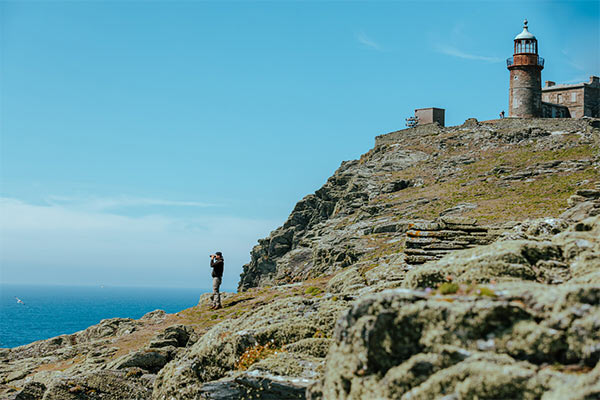 A person birdwatching on the cliffs of the Calf of Man