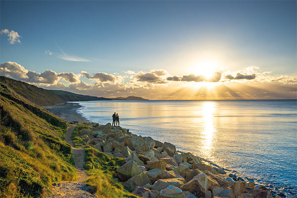The sun setting along the coast at Glen Wyllin on the Isle of Man