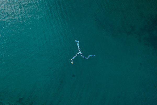  A group of paddleboards forming the Isle of Man flag in the ocean