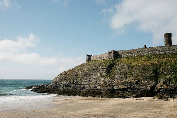 Peel Castle above a sand and shell beach in Peel