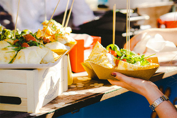 Someone getting street food on a sunny day