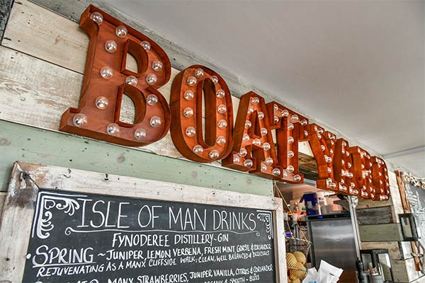 A big red sign reading Boatyard at The Boatyard Restaurant on the Isle of Man