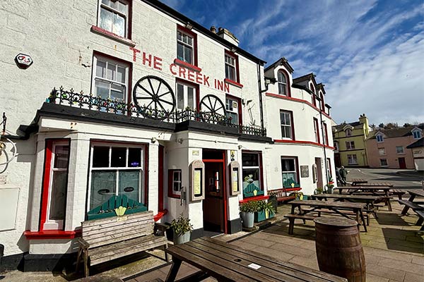 The traditional white exterior of The Creek Inn on the Isle of Man
